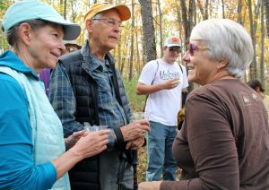 Two hikers chatting with former executive director Susan Lackey