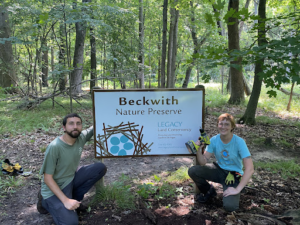Thomas and Dani install a sign at Beckwith Preserve