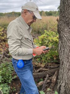 Volunteer Peter Sandretto prepares a geocache at a Legacy preserve