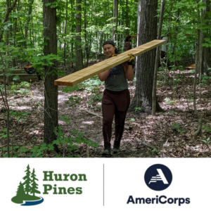 Ally Audia, Huron Pines AmeriCorps member carries lumber
