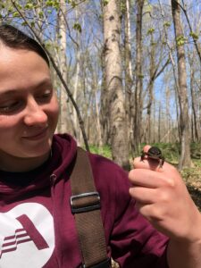 Ally Audia, Huron Pines AmeriCorps member, holds a wood frog