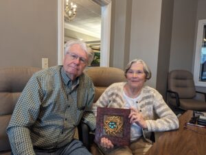 James and Joyce Grace holding Legacy tile at River Hills closing