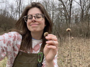 Ari holding brown and dry wild bergamot plant seeds