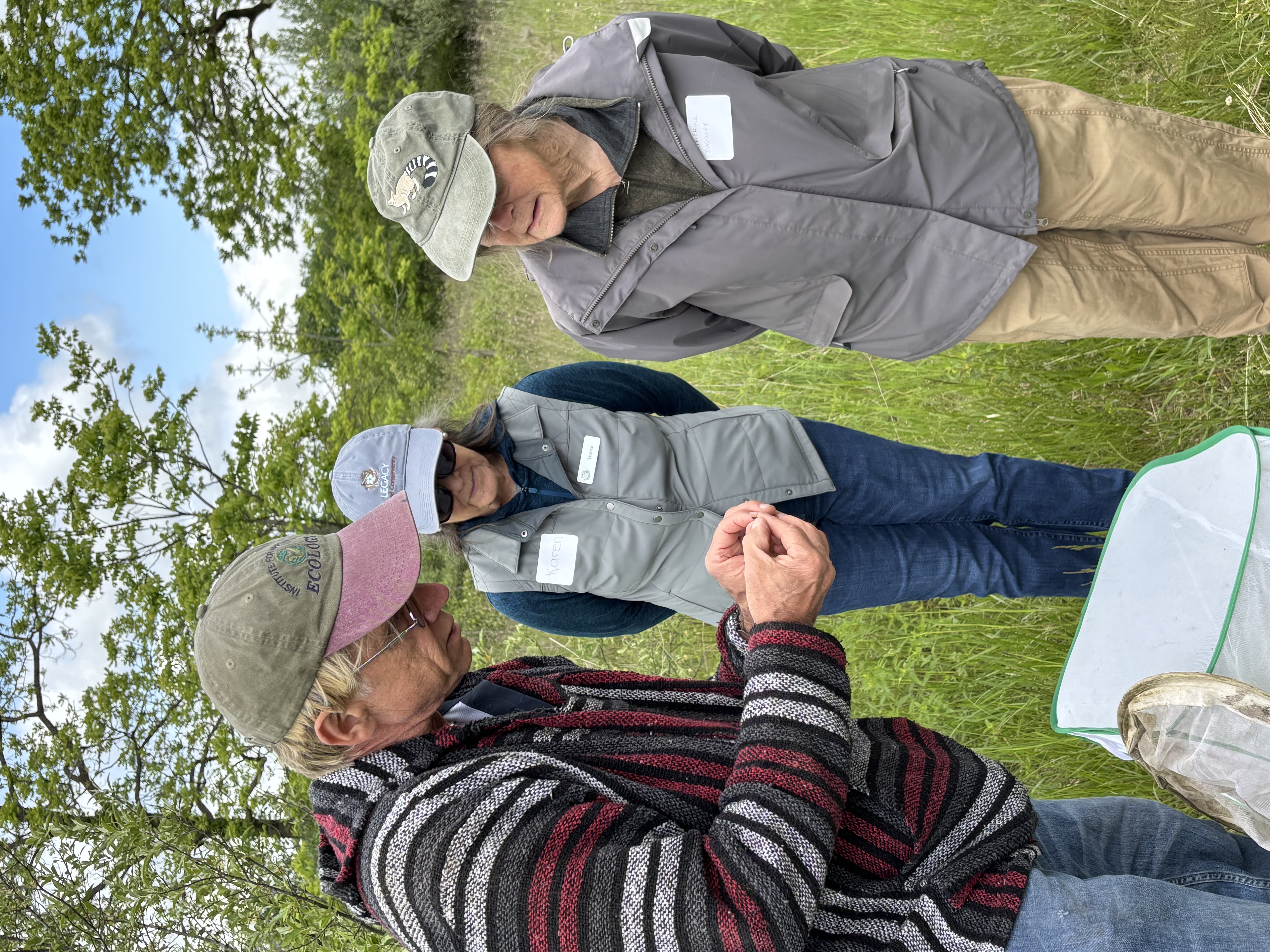 Man showing bug to two people